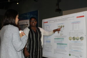 Image of student from MB360 presenting a poster 